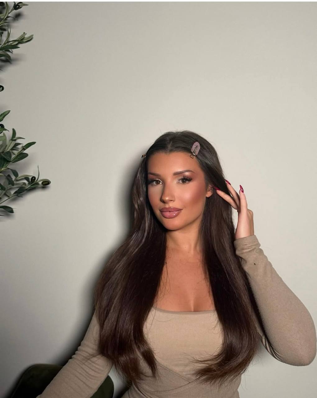 Portrait with long straight dark hair, a soft brown eye, and a pink lip